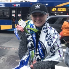 Smiling Solemate with her medal after the NYC United Half Marathon